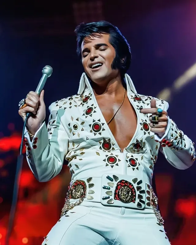 Dean Z performing in a white stage jumpsuit